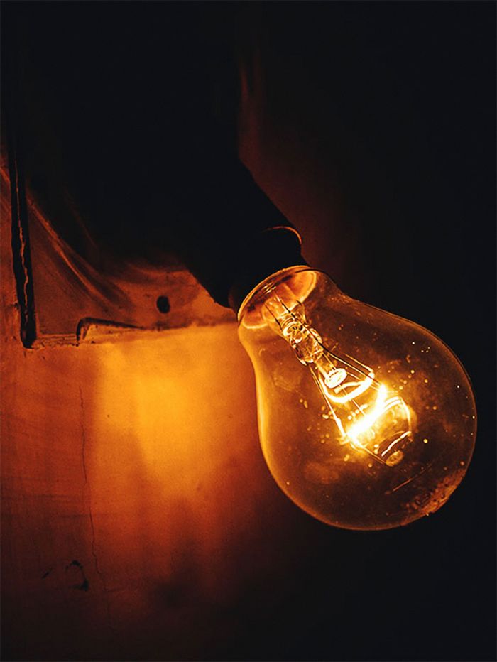 Crafting Captivating Headlines: Your awesome post title goes here A close-up view of an illuminated incandescent light bulb glowing warmly against a dark background.