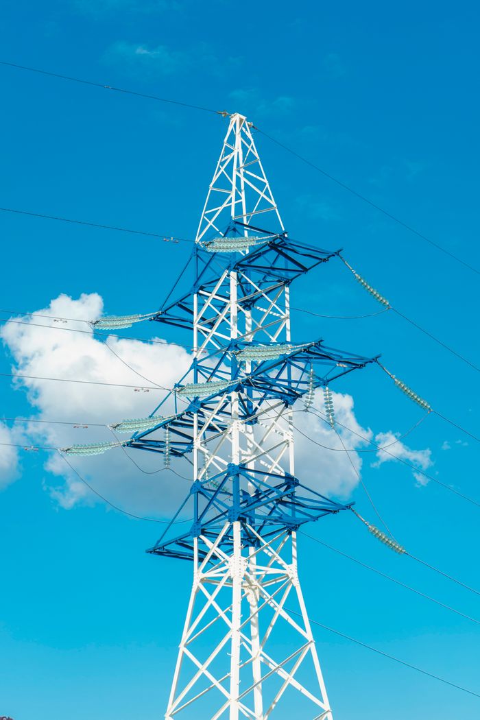 The Art of Drawing Readers In: Your attractive post title goes here A tall electricity transmission tower with wires against a clear blue sky.